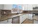 Modern kitchen featuring white cabinets, granite countertops, and stainless steel appliances at 10950 Glenhurst Pass, Duluth, GA 30097