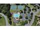 Aerial view of community amenities including a pool, tennis courts, playground, and parking surrounded by lush trees at 55 Little Barley Ln, Grayson, GA 30017
