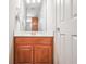 Bathroom featuring a wood vanity, white countertop, and chrome hardware at 55 Little Barley Ln, Grayson, GA 30017