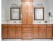 Bathroom featuring dual vanities, a central cabinet and framed mirrors for a touch of elegance at 55 Little Barley Ln, Grayson, GA 30017