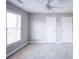 Bedroom features a ceiling fan and two closets at 55 Little Barley Ln, Grayson, GA 30017
