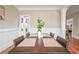 Dining room area featuring wood floors, a large table and a plant in the center at 55 Little Barley Ln, Grayson, GA 30017