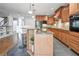 Bright kitchen boasts stainless appliances, granite counters, a central island, and stylish pendant lighting at 55 Little Barley Ln, Grayson, GA 30017