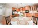 Beautiful kitchen with wooden cabinets, a central island with bar stools, and an adjacent breakfast area at 55 Little Barley Ln, Grayson, GA 30017