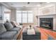 Features a fireplace, a large grey sectional couch, and an ottoman at 55 Little Barley Ln, Grayson, GA 30017