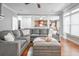 Living room with grey sectional couch, ottoman, and open access to kitchen at 55 Little Barley Ln, Grayson, GA 30017