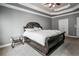 Large main bedroom featuring a beautiful tray ceiling and neutral-colored carpet at 55 Little Barley Ln, Grayson, GA 30017