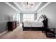 Spacious bedroom with tray ceiling, dark wood furniture, and bright windows at 55 Little Barley Ln, Grayson, GA 30017