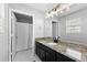 Bathroom featuring granite counters, dark cabinets, and a shower/tub combination at 1075 Peachtree Walk # A-307, Atlanta, GA 30309