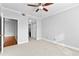 This spare bedroom has neutral walls and carpet, a ceiling fan, and includes access to an adjacent room at 1075 Peachtree Walk # A-307, Atlanta, GA 30309