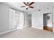 Neutral bedroom with a ceiling fan, carpeted floors, and a window with natural light at 1075 Peachtree Walk # A-307, Atlanta, GA 30309