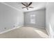 A standard bedroom features neutral walls, neutral carpet, a ceiling fan, and a window at 1075 Peachtree Walk # A-307, Atlanta, GA 30309