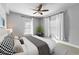 This staged bedroom offers neutral walls, neutral carpet, and windows providing natural light at 1075 Peachtree Walk # A-307, Atlanta, GA 30309