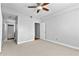 Neutral bedroom with a ceiling fan, carpeted floors, and access to a hallway at 1075 Peachtree Walk # A-307, Atlanta, GA 30309