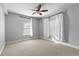 This spare bedroom offers neutral walls, neutral carpet, and windows providing natural light at 1075 Peachtree Walk # A-307, Atlanta, GA 30309