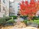 Charming courtyard with benches, mature trees, and well-maintained landscaping, ideal for relaxation at 1075 Peachtree Walk # A-307, Atlanta, GA 30309