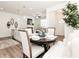 Cozy dining area with a round table, white upholstered chairs, and natural light, creating a comfortable eating space at 2456 Honey Way, Conyers, GA 30013