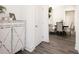 Bright hallway featuring light gray floors, a white cabinet, white doors, and an adjacent dining area at 2456 Honey Way, Conyers, GA 30013