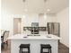 Bright kitchen with stainless steel appliances, white cabinets, island with seating, and modern pendant lighting at 2456 Honey Way, Conyers, GA 30013