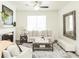 Inviting living room with a fireplace, comfortable seating, a decorative mirror, and natural light from a large window at 2456 Honey Way, Conyers, GA 30013