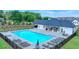 Community pool with lounge chairs, outdoor seating, and a clubhouse for residents' enjoyment at 2456 Honey Way, Conyers, GA 30013