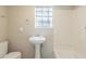 Standard bathroom with pedestal sink, window, and shower at 3090 Chimney W Rdg, Snellville, GA 30078