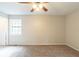 Spacious bedroom featuring neutral walls, plush carpeting, and a ceiling fan for added comfort at 3090 Chimney W Rdg, Snellville, GA 30078