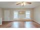 Bright living room with hardwood floors, a ceiling fan, and natural light at 3090 Chimney W Rdg, Snellville, GA 30078