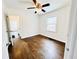 Bright bedroom with hardwood floors, white paneled walls, a ceiling fan, and natural light at 4206 Sherwood Ave, Decatur, GA 30035