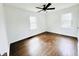 Spacious bedroom featuring hardwood floors, two windows, and a ceiling fan at 4206 Sherwood Ave, Decatur, GA 30035