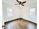 Bedroom with wood floors, white walls, two windows, and a ceiling fan at 4206 Sherwood Ave, Decatur, GA 30035