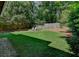 Large backyard with grass, a wooden fence and two white chairs, perfect for outdoor entertaining and relaxation at 4580 Windsor Park Place, Atlanta, GA 30342