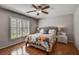 Comfortable bedroom with a ceiling fan, shutters, and hardwood flooring at 4580 Windsor Park Place, Atlanta, GA 30342