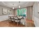 Elegant dining room with tray ceilings, hardwood floors, wainscoting, and large windows for natural light at 4580 Windsor Park Place, Atlanta, GA 30342