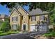 Front exterior of a home with traditional architecture, a two car garage, and a well-kept lawn at 4580 Windsor Park Place, Atlanta, GA 30342