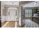 Welcoming foyer with hardwood floors, white trim, and a view into an office through glass French doors at 4580 Windsor Park Place, Atlanta, GA 30342