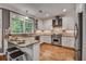 Bright kitchen with white cabinets, granite countertops, stainless steel appliances, and a large window at 4580 Windsor Park Place, Atlanta, GA 30342