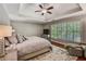 Relaxing primary bedroom showcasing a tray ceiling and plenty of natural light at 4580 Windsor Park Place, Atlanta, GA 30342