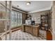 Well-lit home office with a wooden desk, comfortable chair, bookshelves, and a view of the front yard at 4580 Windsor Park Place, Atlanta, GA 30342