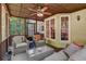 Comfortable screened-in porch with wicker chairs and couch, perfect for outdoor relaxation overlooking private backyard at 4580 Windsor Park Place, Atlanta, GA 30342