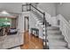 Elegant staircase with carpeted steps, white railing, and black accents, leading to the upper level at 4580 Windsor Park Place, Atlanta, GA 30342