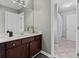 Bathroom with wood vanity, white countertops and a walk in shower with sliding door at 923 Buckhorn Bnd, Locust Grove, GA 30248