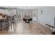 Open dining area featuring tile floors, a modern chandelier, and natural light from two large windows at 923 Buckhorn Bnd, Locust Grove, GA 30248