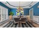 Elegant dining room featuring stylish chandelier, modern art, and a bold black and white rug at 923 Buckhorn Bnd, Locust Grove, GA 30248