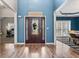 Inviting entrance with a decorative door, wood floors, and a view of the adjacent dining room at 923 Buckhorn Bnd, Locust Grove, GA 30248