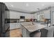 Beautiful kitchen with white cabinets, gray backsplash, stainless steel appliances and granite countertops at 923 Buckhorn Bnd, Locust Grove, GA 30248