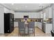 Bright kitchen featuring white cabinets, gray backsplash, stainless steel appliances, and granite countertops at 923 Buckhorn Bnd, Locust Grove, GA 30248