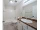 Bathroom features a white vanity with brown countertop, shower-tub combo, and tile flooring at 1838 Nicole Ln, Lithonia, GA 30058