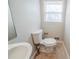 Powder room with a sink, toilet, and a small window at 1838 Nicole Ln, Lithonia, GA 30058