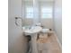 Half bath featuring pedestal sink, tiled floor, and window at 1838 Nicole Ln, Lithonia, GA 30058